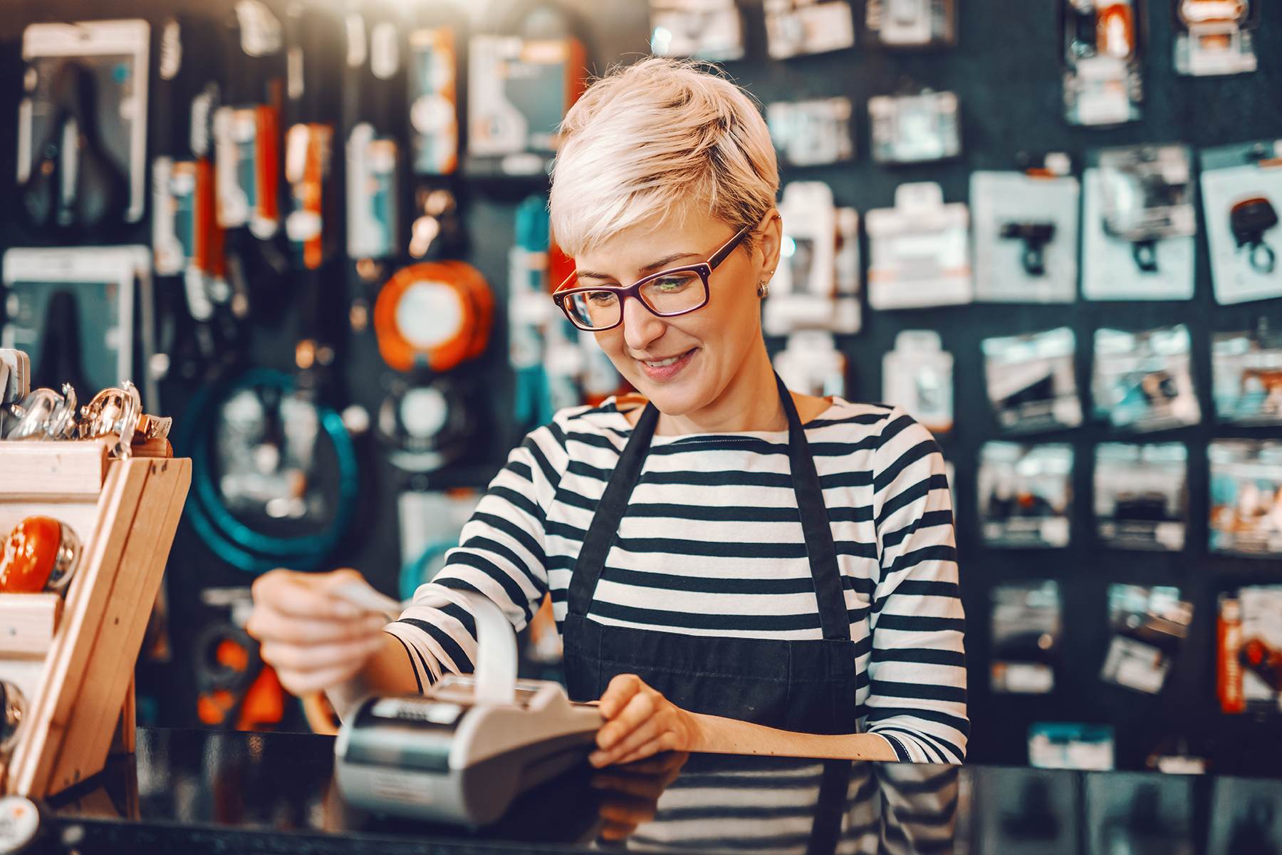 Smiling Caucasian female worker with short blonde hair and eyegl